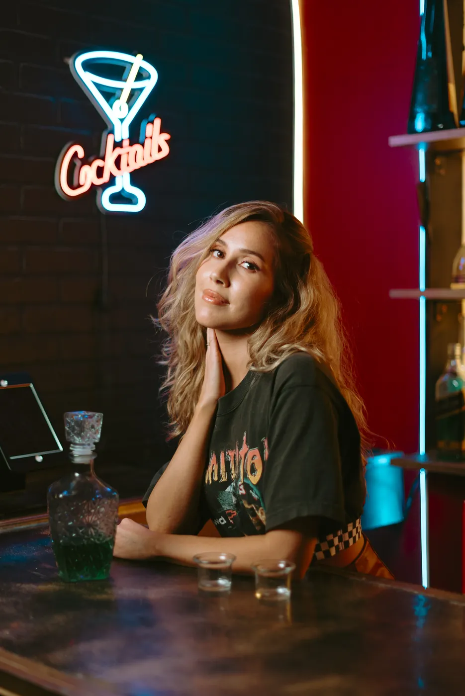 A portrait at a neon-lit bar photographed without a diffusion filter