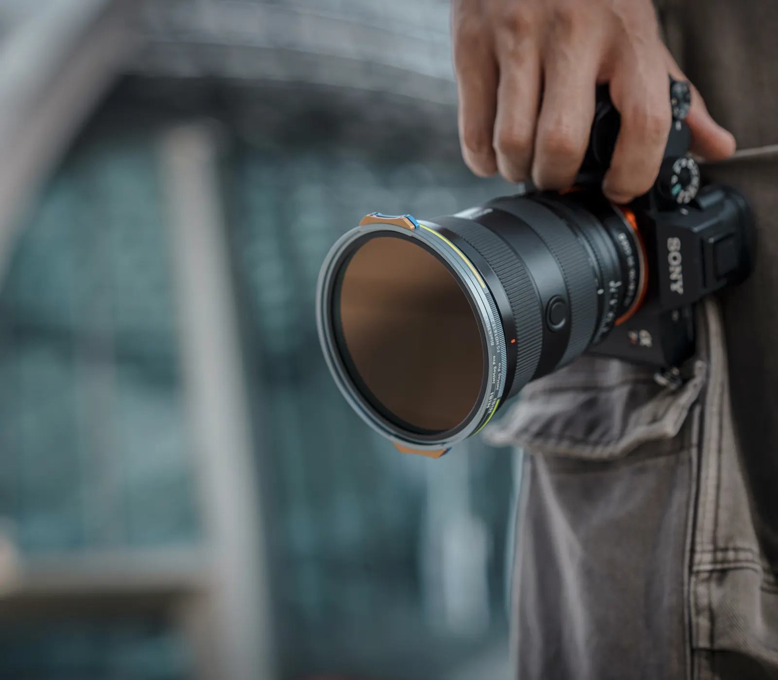A photographer carrying a Sony camera with a NiSi JetMag Pro filter