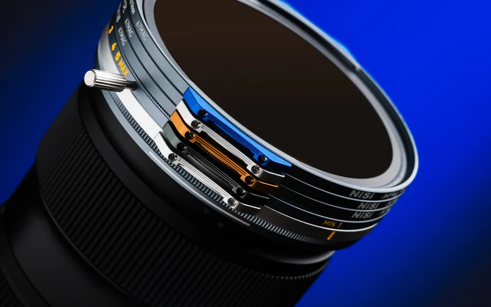 A stack of NiSi JetMag Pro 67MAG filters with coloured handles on a lens