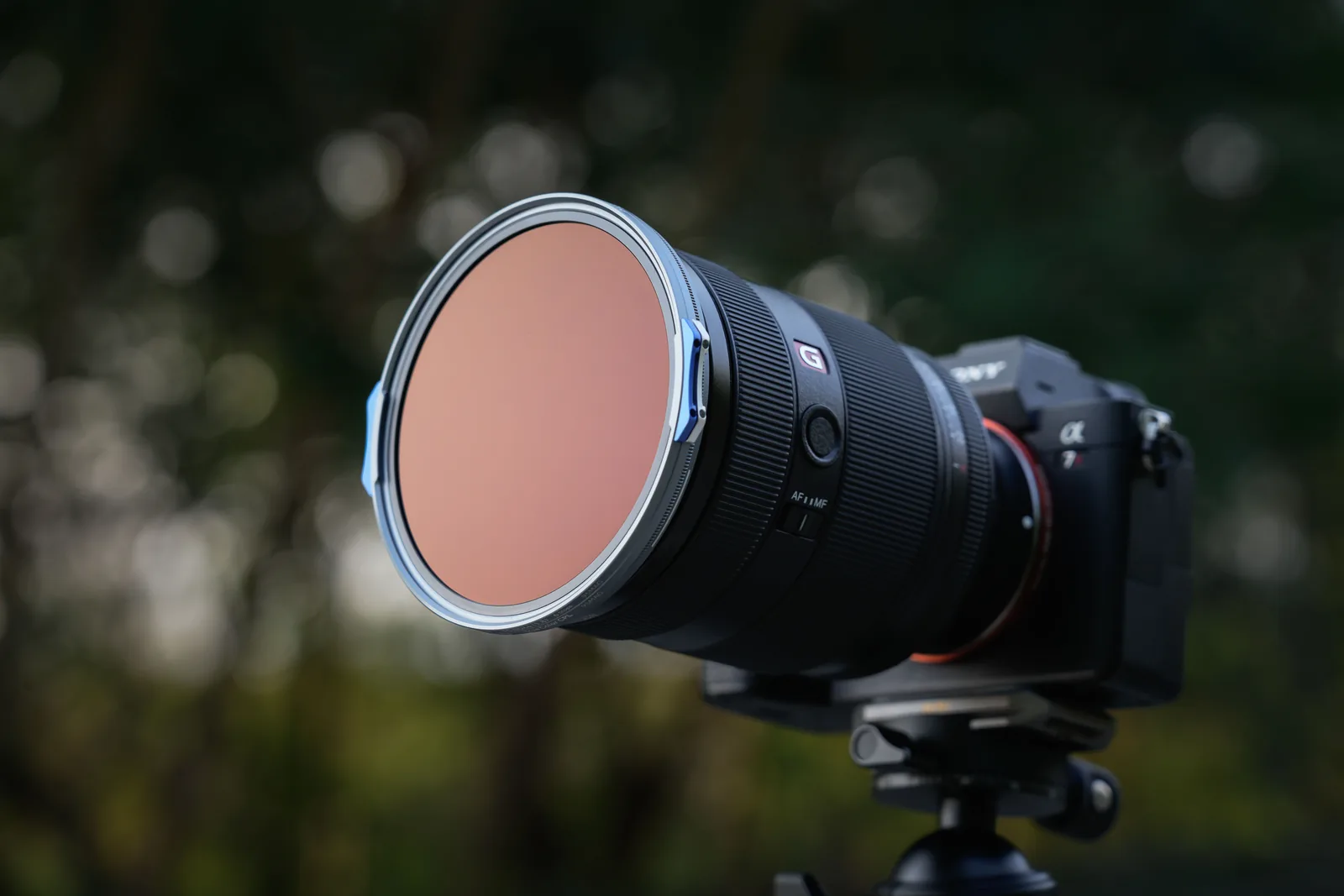 A 95MAG filter mounted on a zoom lens on a tripod