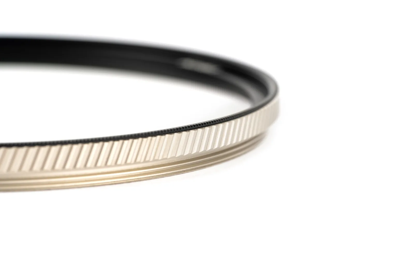 Close-up of the two-tone brass frame and twill knurling on an Armor FX filter