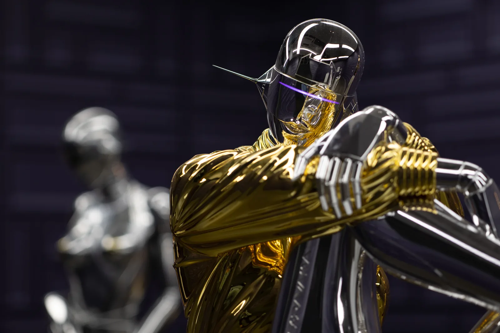 A chrome and gold figure used to test chromatic aberration on the Athena lenses