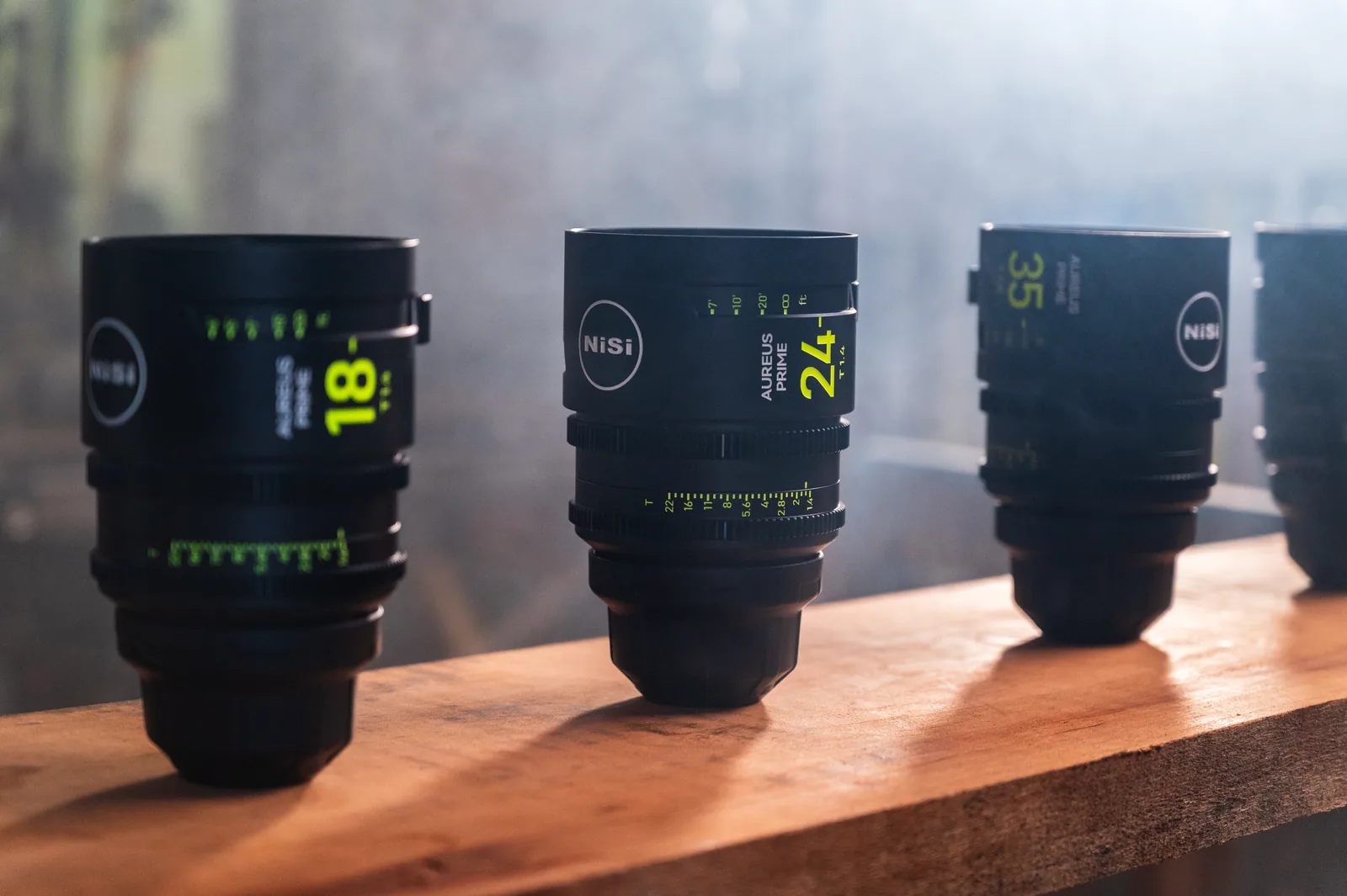 AUREUS PRIME lenses standing in a row on a wooden bench