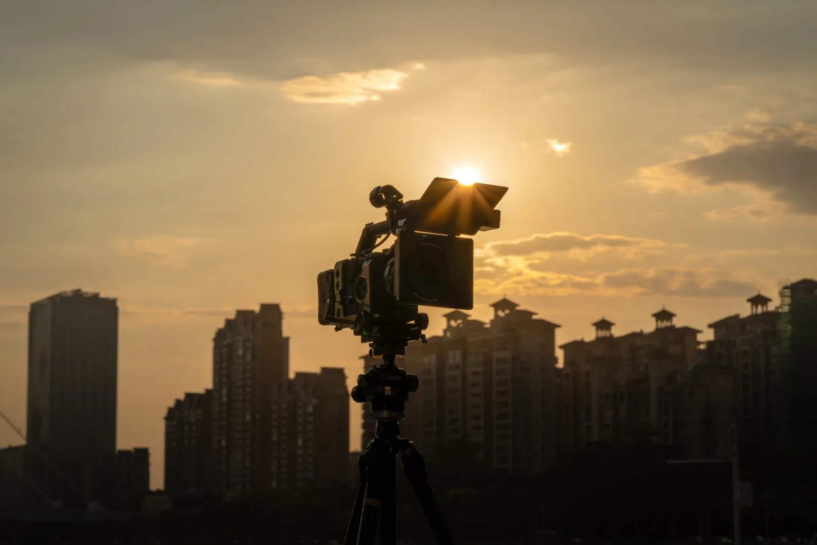 NiSi JetMag Pro Matte Box on a tripod, silhouetted against the setting sun