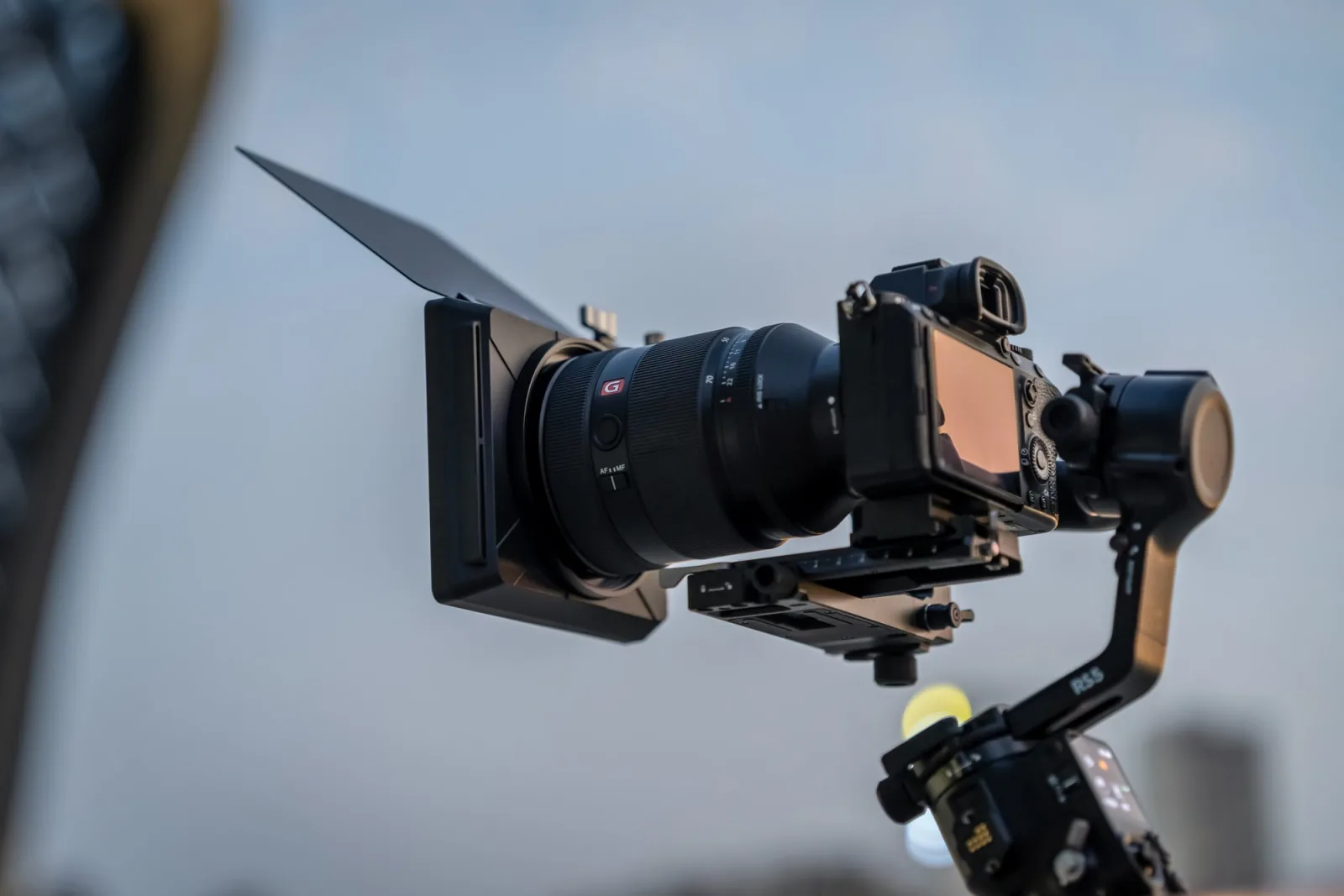 NiSi JetMag Pro Matte Box with top flag raised, on a tripod against open sky