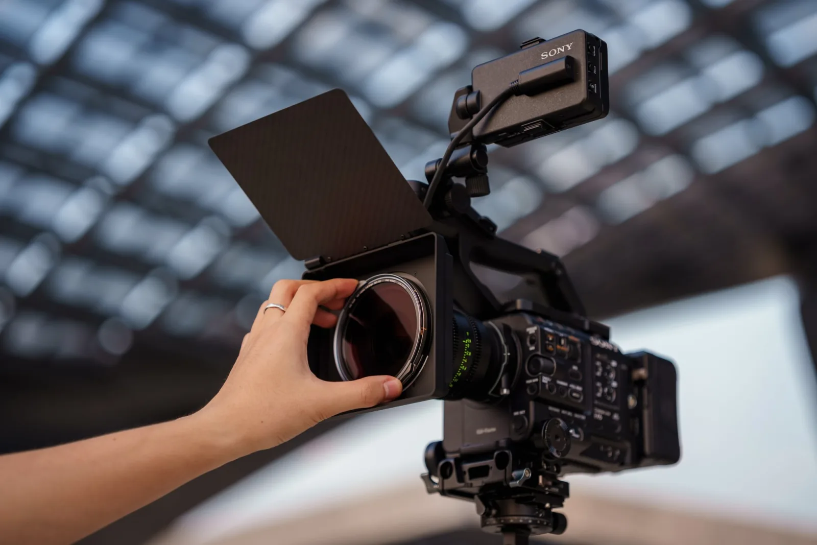 A hand snapping a filter into the NiSi JetMag Pro Matte Box on a cinema rig
